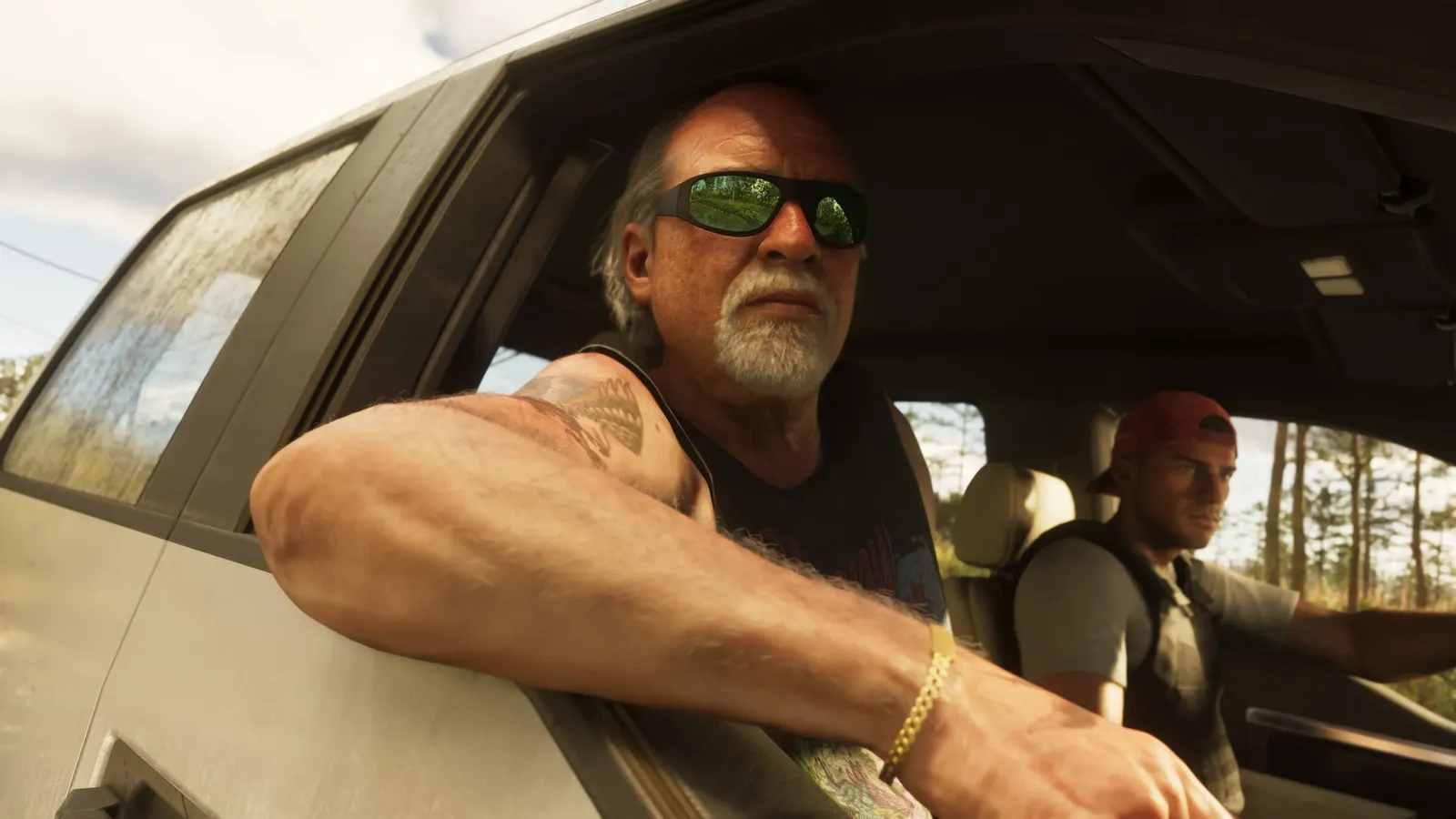 Brian Heder leans from a silver pickup's passenger window while Jason sits at the wheel.