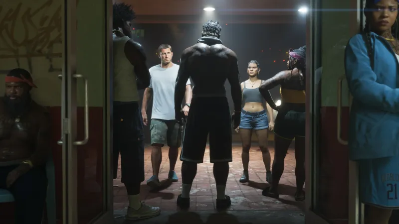 Jason and Lucia face a group of people inside a crowded gym in an official GTA 6 screenshot.