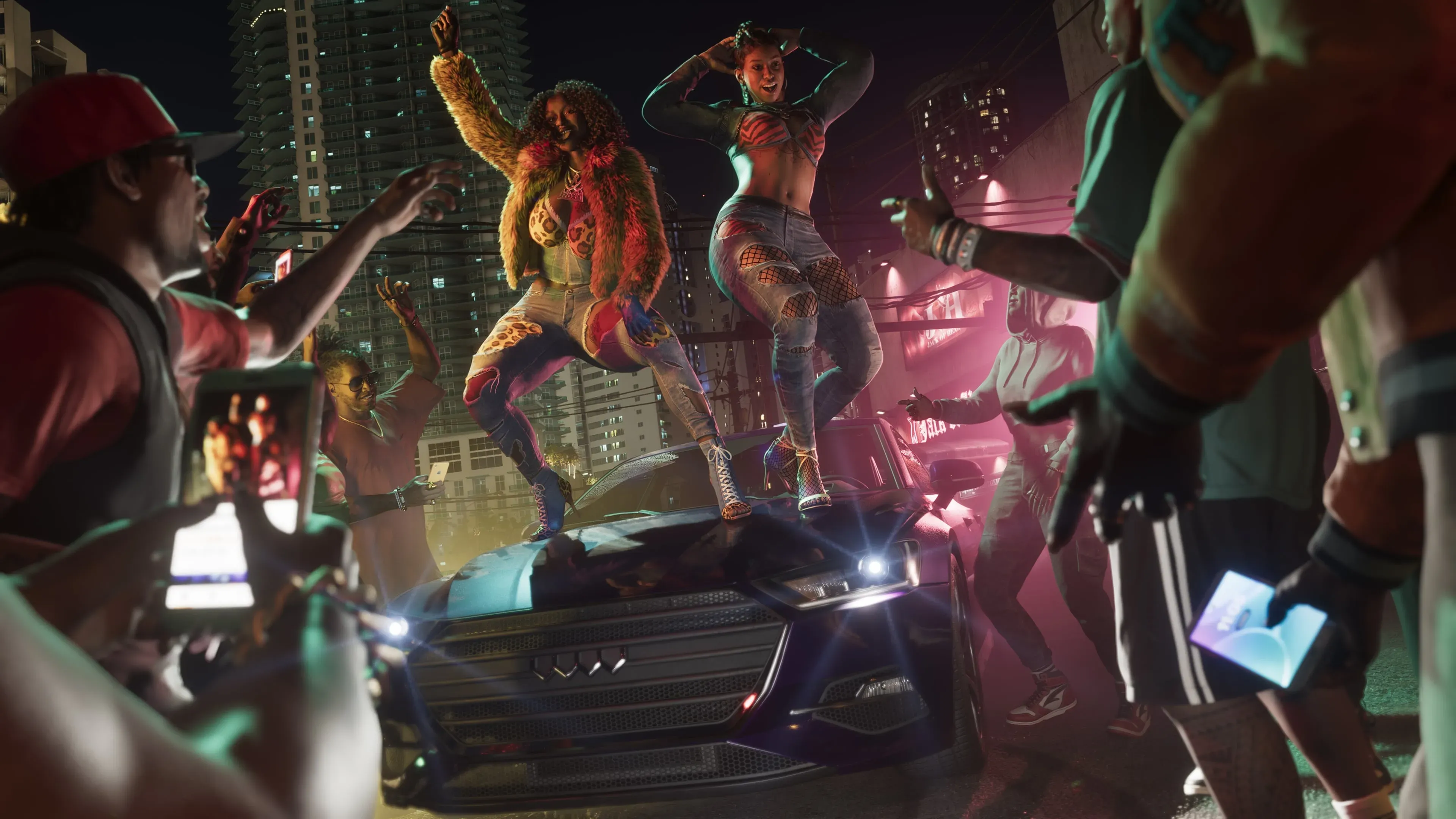 Bae-Luxe and Roxy performing on top of a car as a crowd films them in GTA 6.