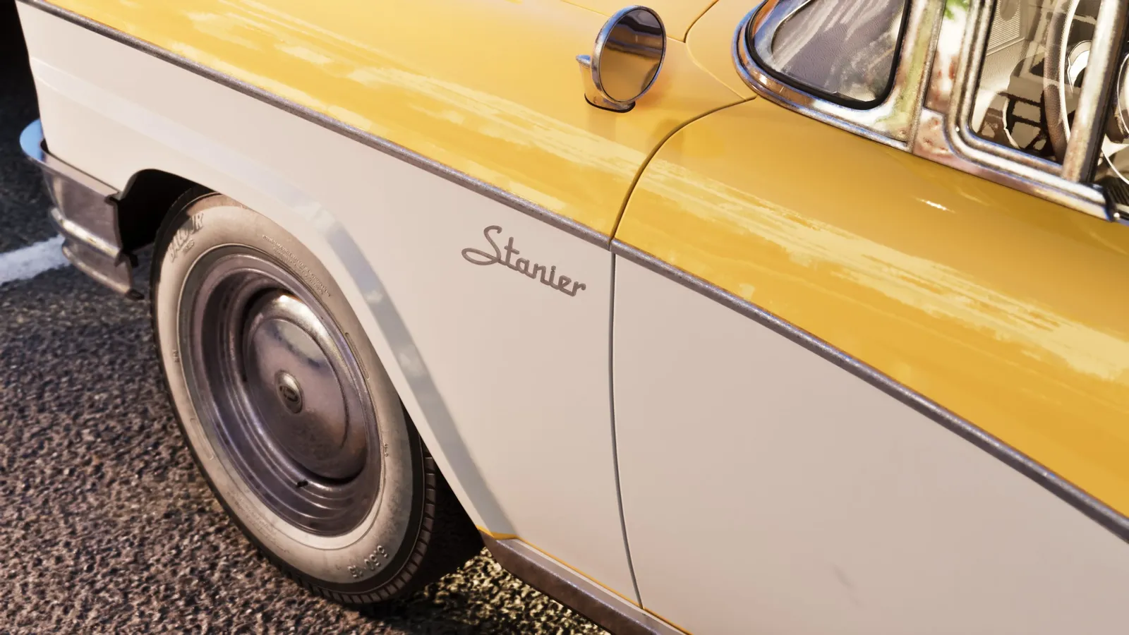 Close view of the Stanier badge, front wheel and yellow-and-white bodywork.